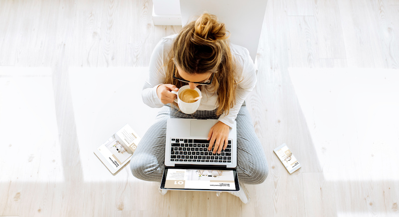 top view of woman working on website blog drinking coffee